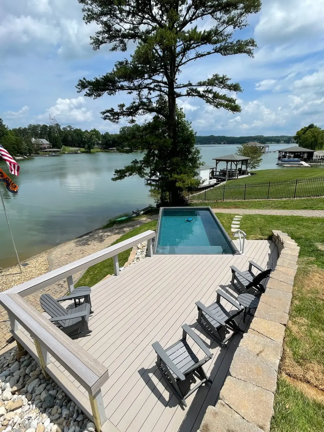 above ground plunge pool with wood deck overlooking a lake